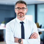 Shot of a mature businessman standing with his arms crossed crossed in an office at work