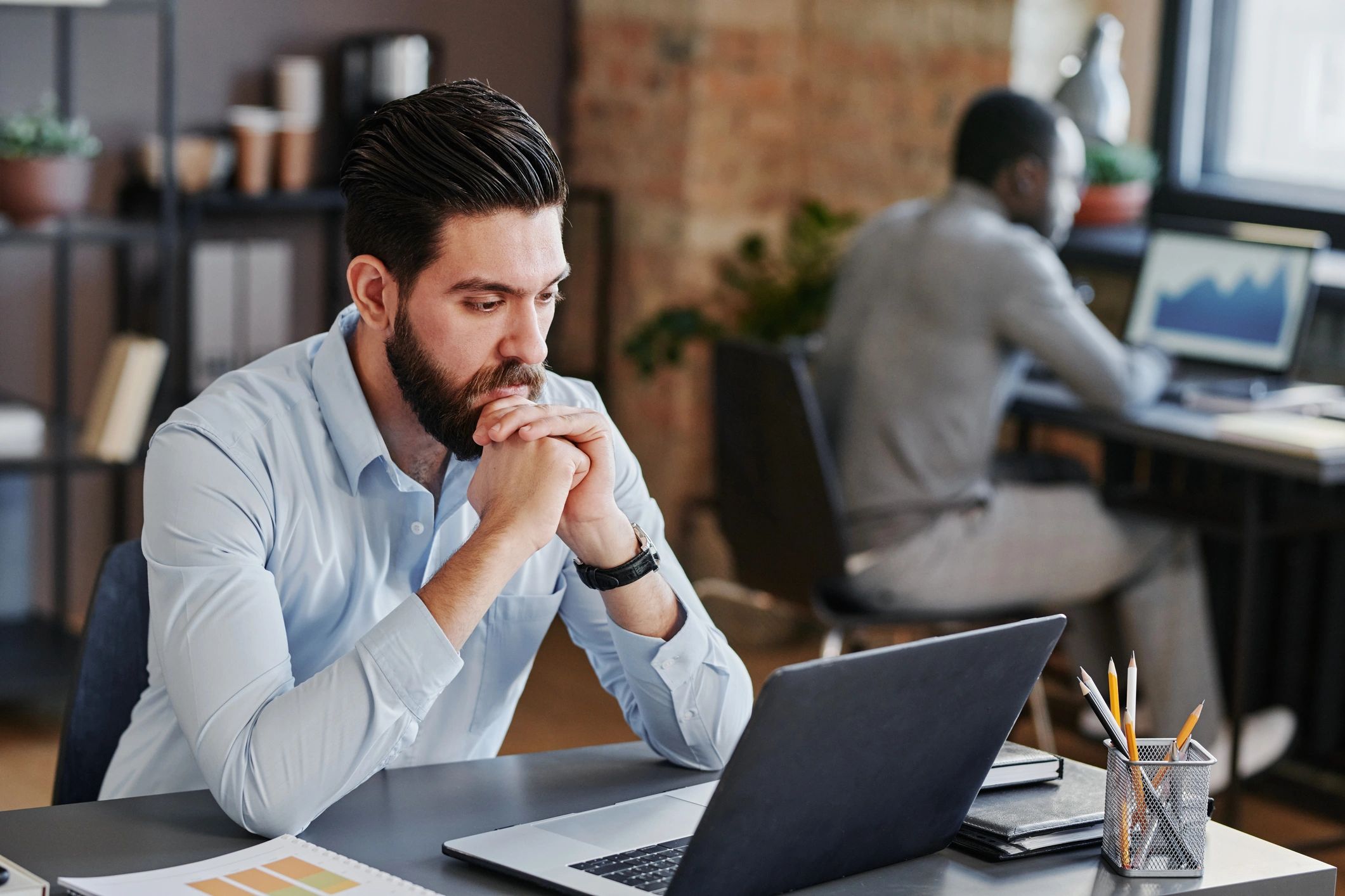 Property manager reviewing plans and budget on a computer