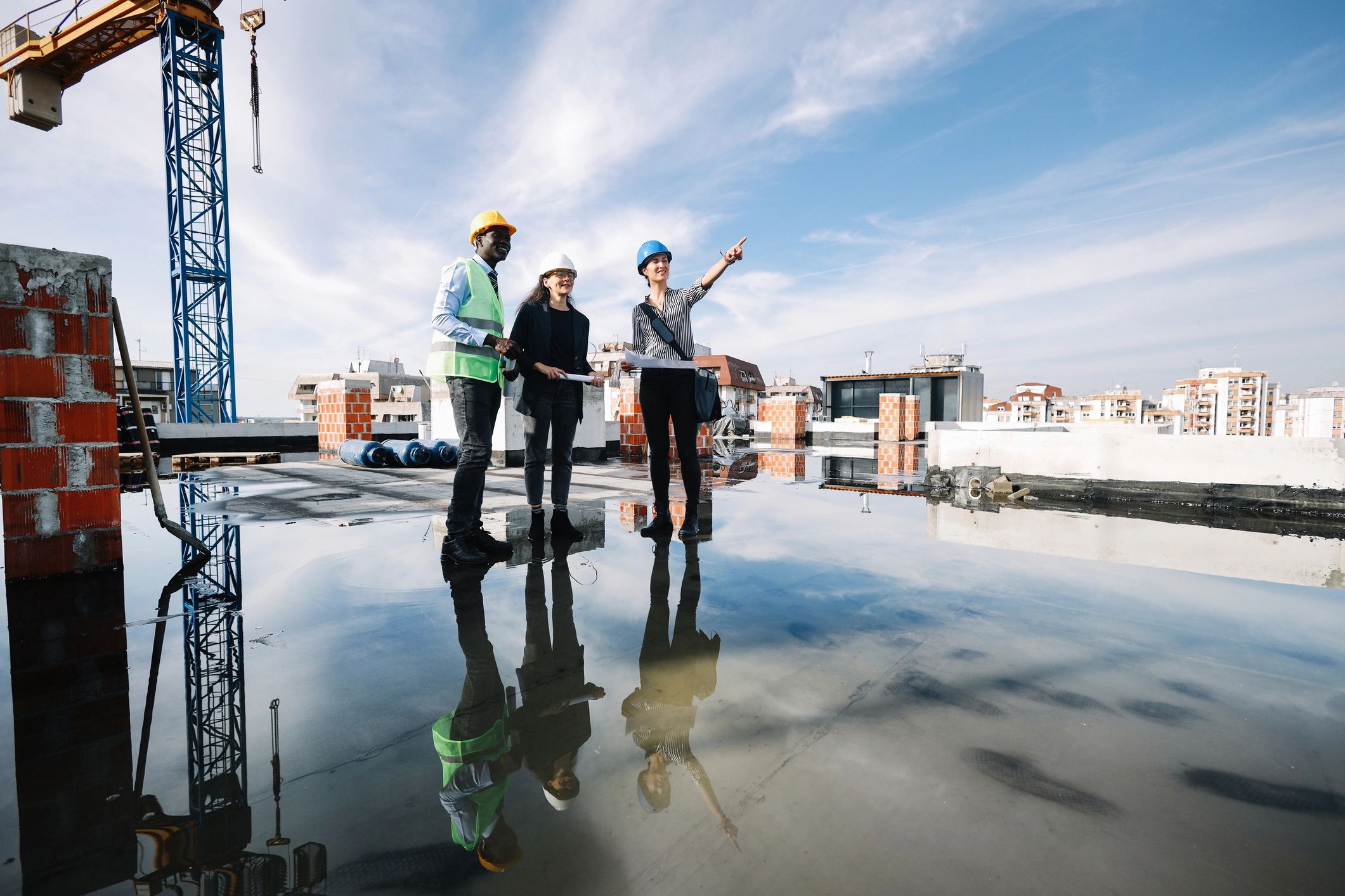 Team meeting at a construction site reviewing plans