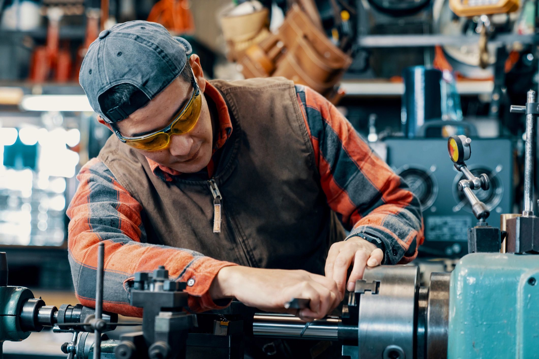 Skilled worker operating equipment in a metal fabrication workshop