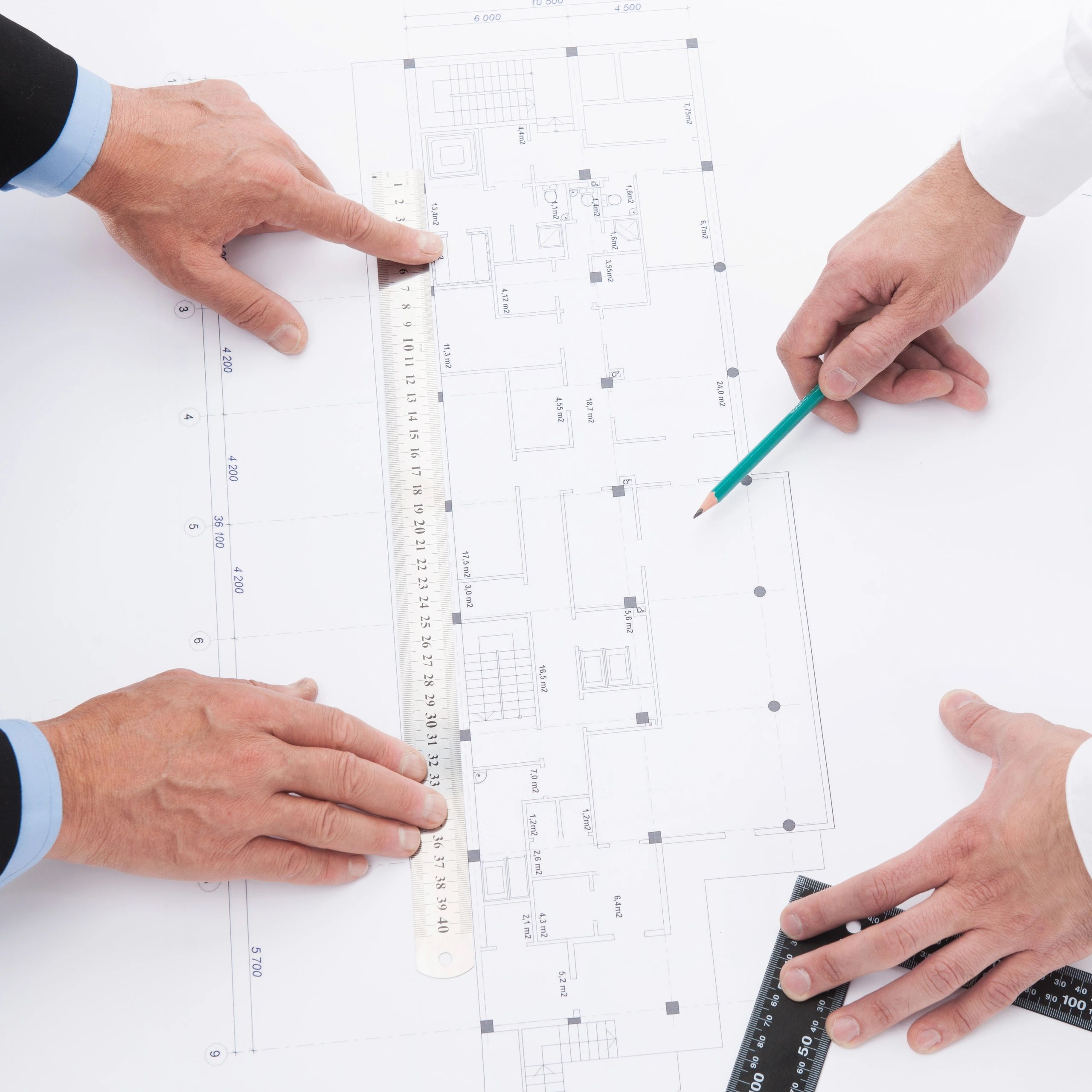 Engineering team reviewing retrofit plans for structural upgrades