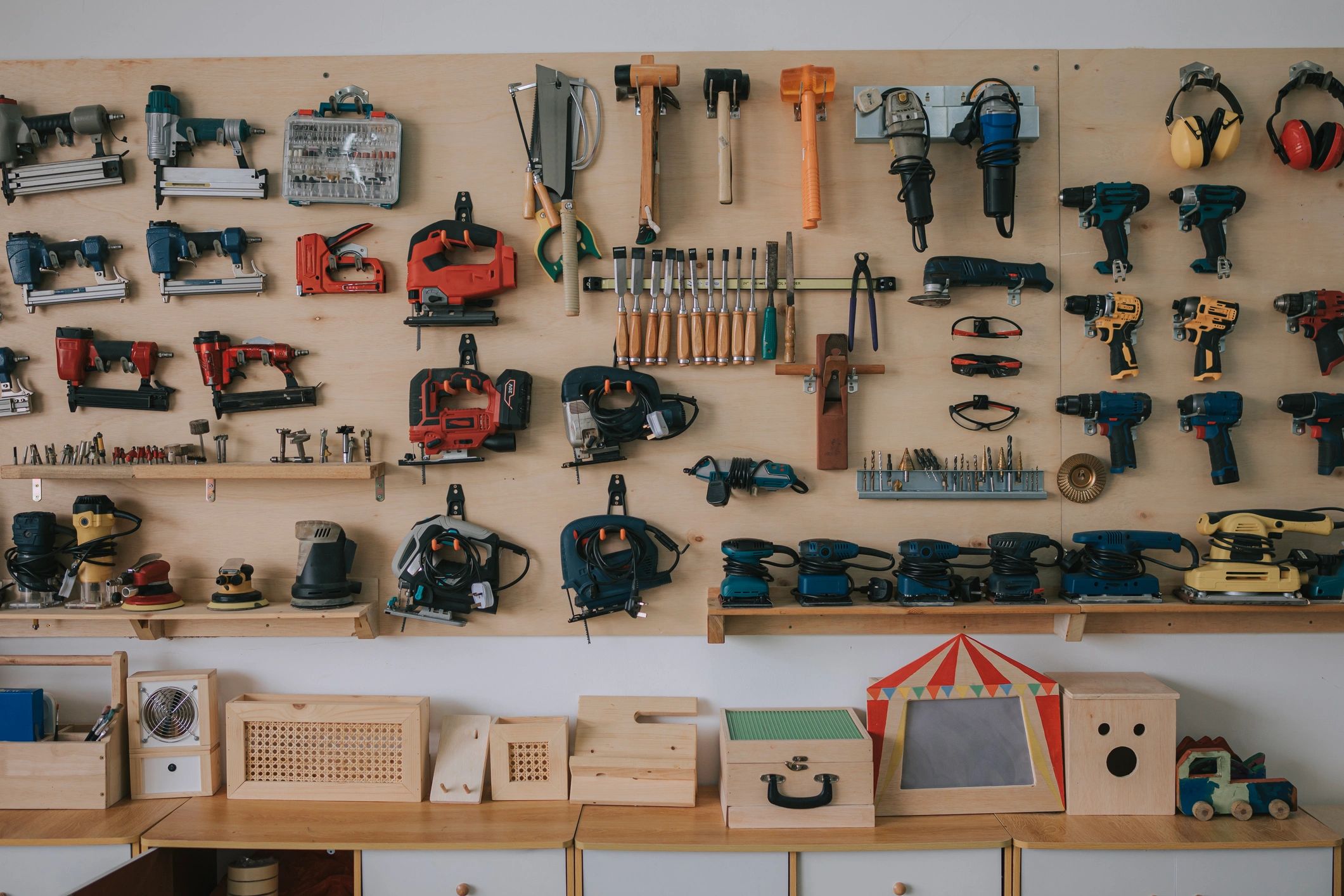 Hand tools and safety equipment arranged on a workshop bench