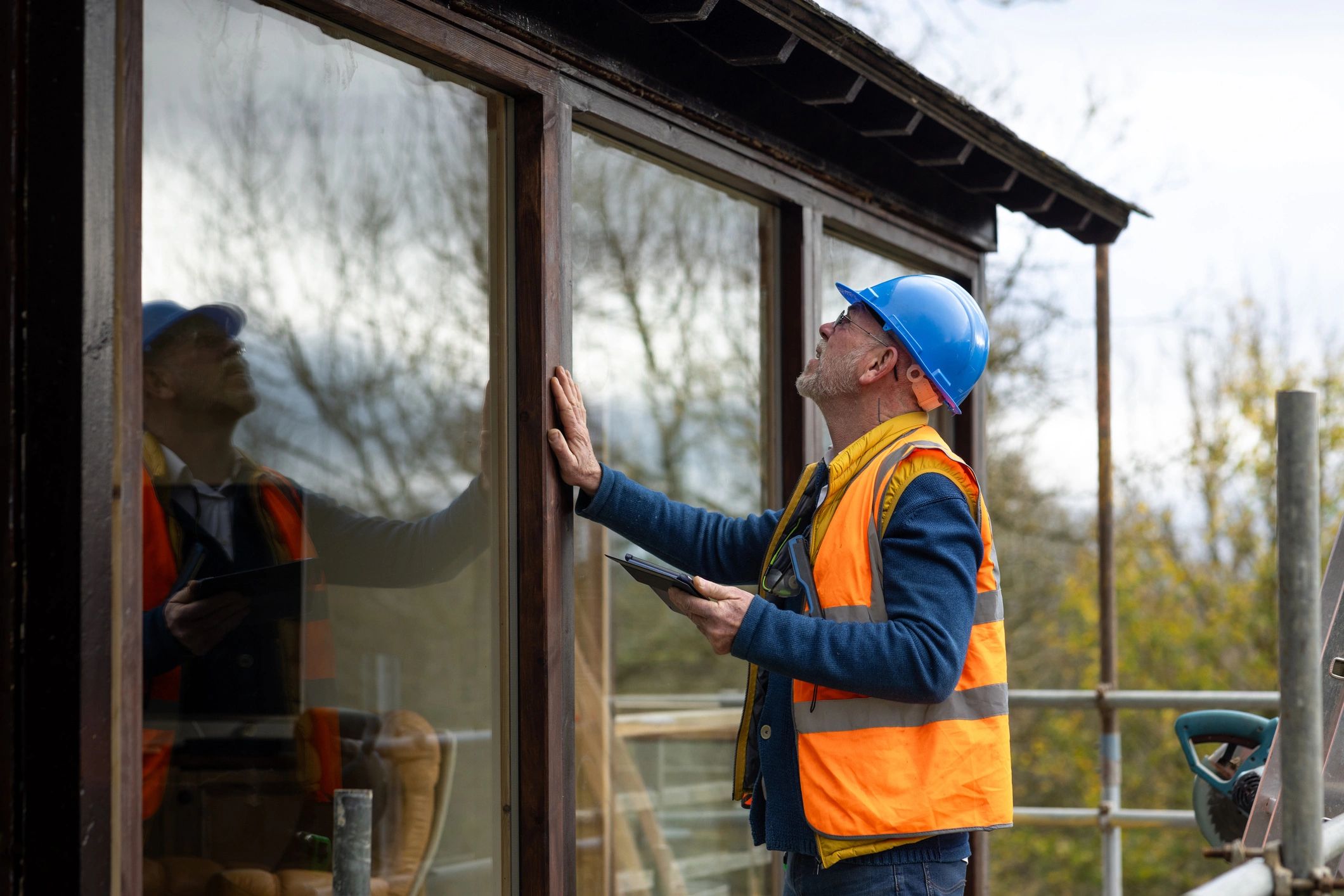 Inspector reviewing building envelope condition during a site assessment