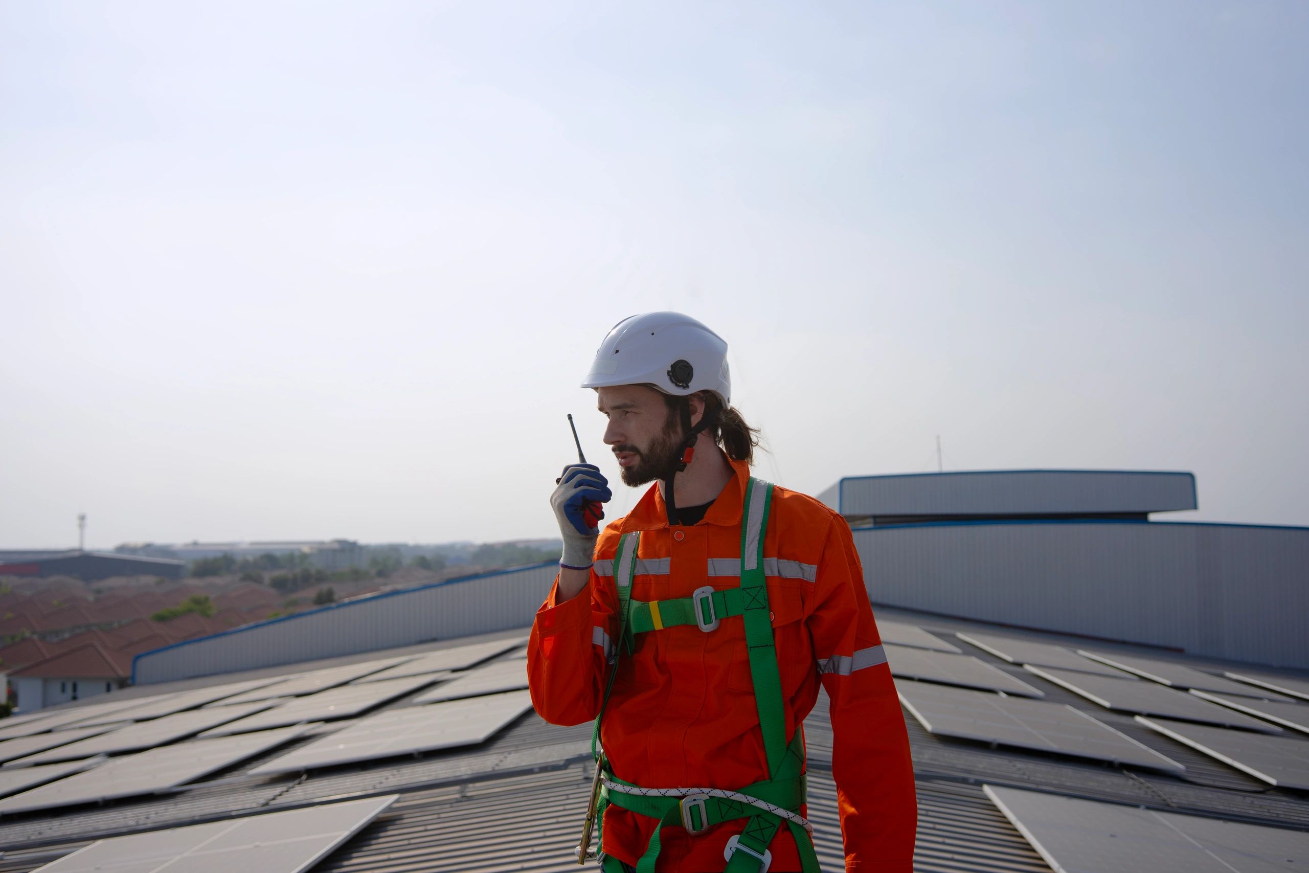 Technician performing rooftop maintenance inspection on a commercial facility