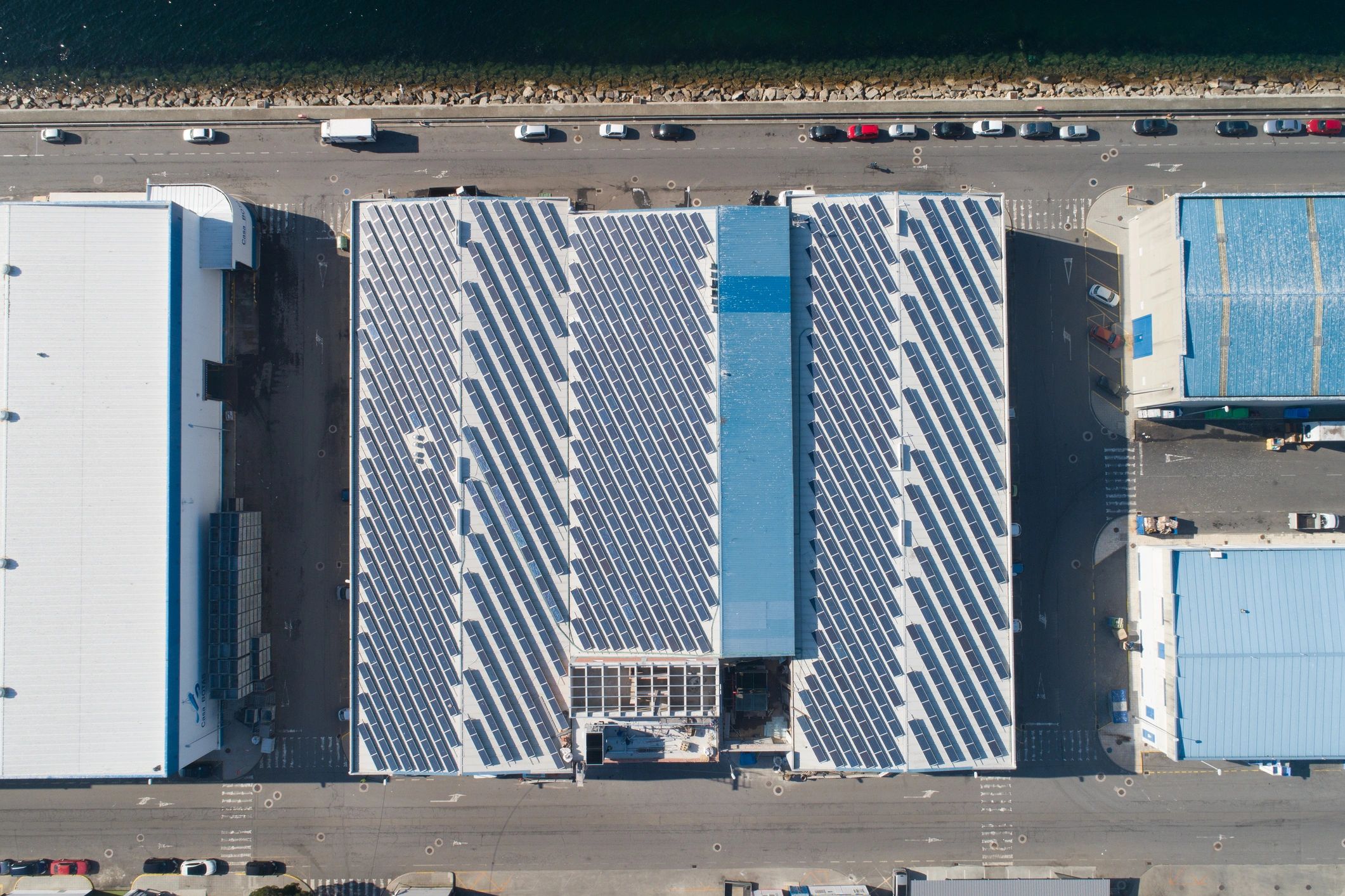 Aerial view of an industrial rooftop with solar panels
