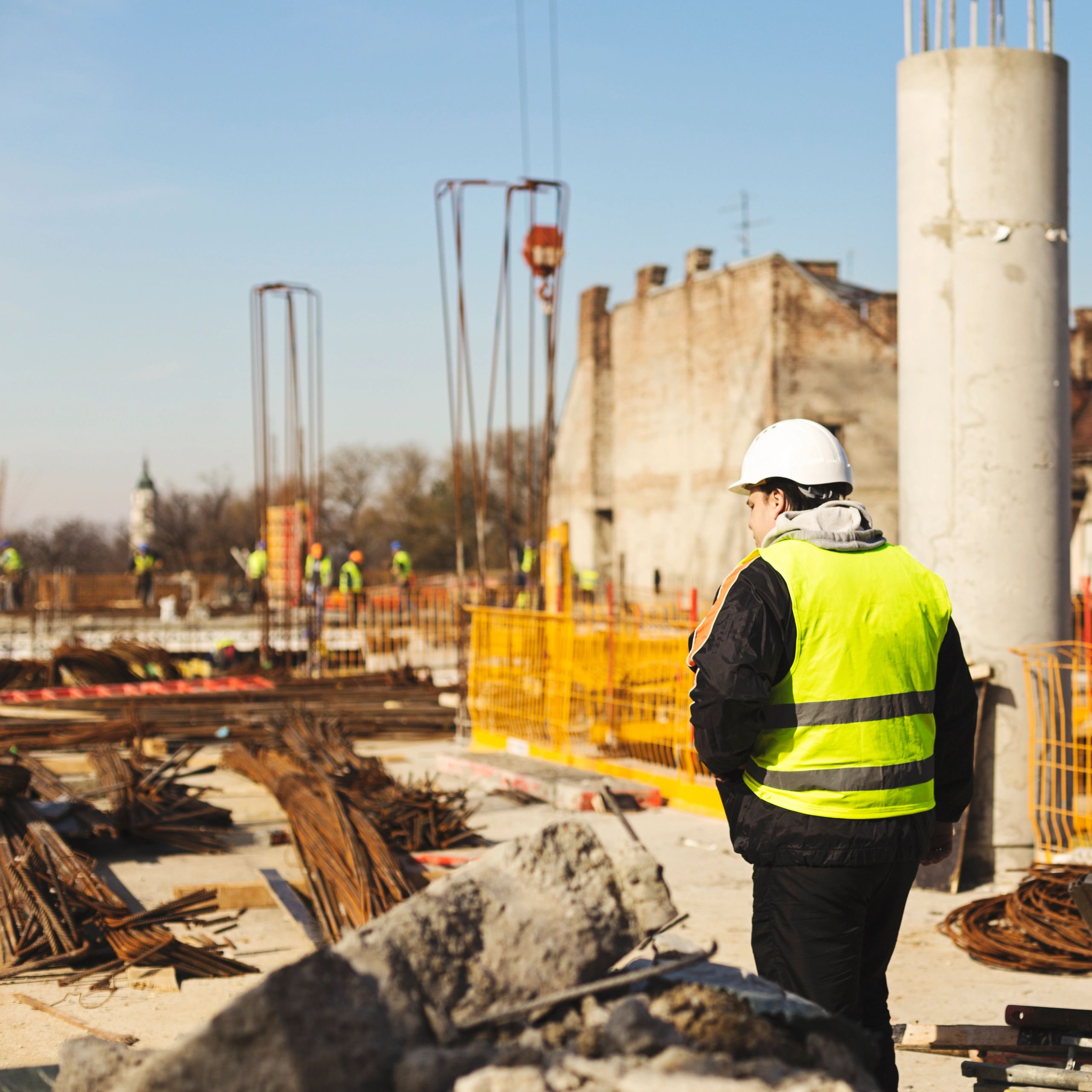 Construction foreman inspecting a worksite for foundation stabilization planning